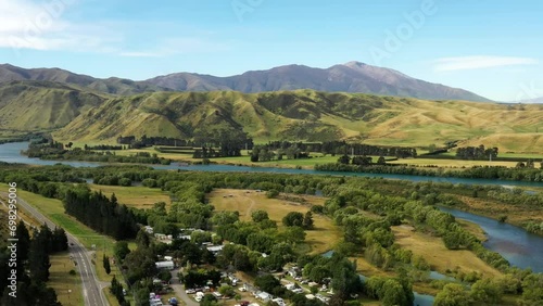 Kurow township on Waitaki river valley in mountains of New Zealand aerial 4k.
 photo