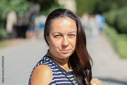 middle-aged Oriental woman in a blurred cityscape, Jewish. Concept: refugees from the East in Europe,  photo