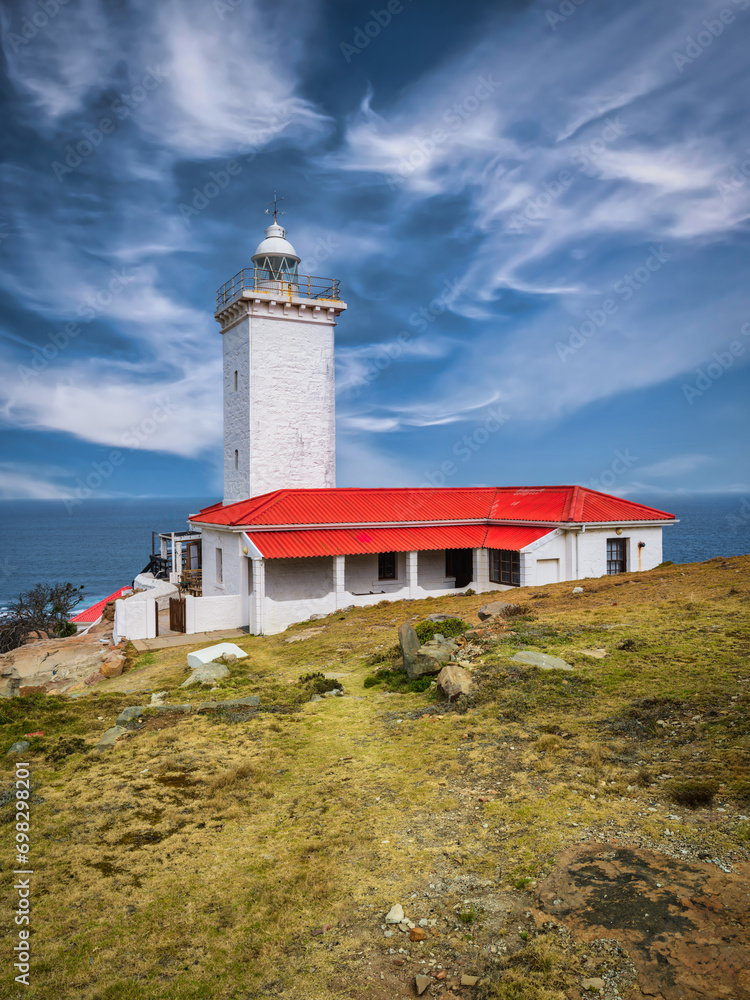 Vertical shot of Cape St Blaize Lighthouse with blue sky and white cloud, Mossel Bay, Western Cape, South Africa Vertical shot of Cape St Blaize Lighthouse with blue sky and white cloud, Mossel Bay, Western Cape, South Africa