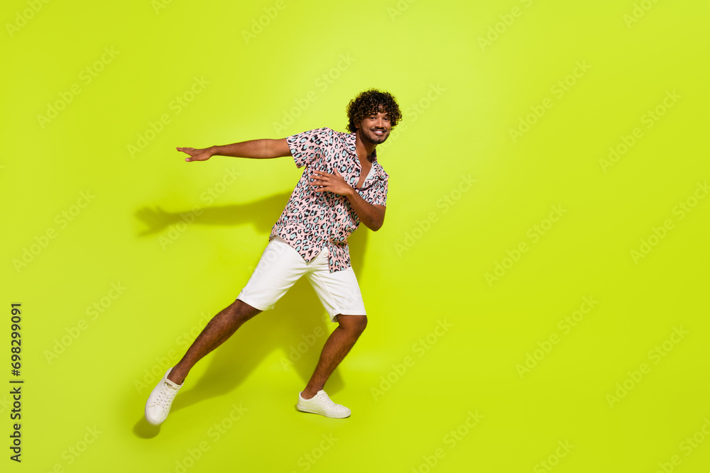 Full size photo of handsome young guy cheerful discotheque dressed stylish leopard print outfit isolated on yellow color background