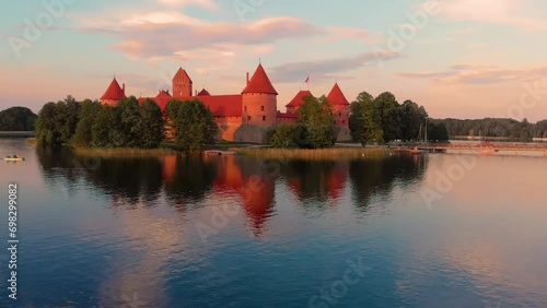Mesmerizing view of trakai island castle in trakai, lithuania surrounded by calm water.  photo