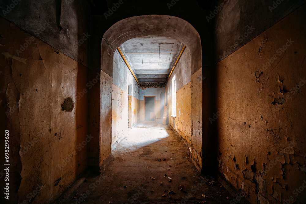Dark vaulted corridor in old abandoned building