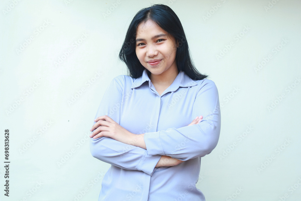 pretty asian young woman look to camera with happy face and folded arm wear formal shirt standing over white background pretty asian young woman look to camera with happy face and folded arm wear formal shirt standing over white background