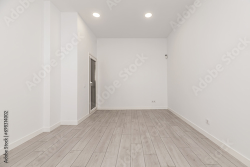 An empty room in an apartment with white walls 