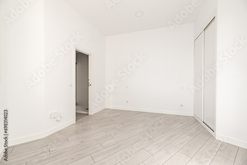 Wallpaper Mural A room with irregular walls with a built-in wardrobe with white sliding doors Torontodigital.ca