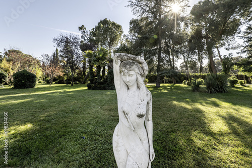 A decorative statue in the middle of a private garden