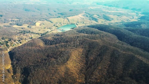 Drone shot over Moslavina mountain range and a lake in Podgaric in a winter day photo