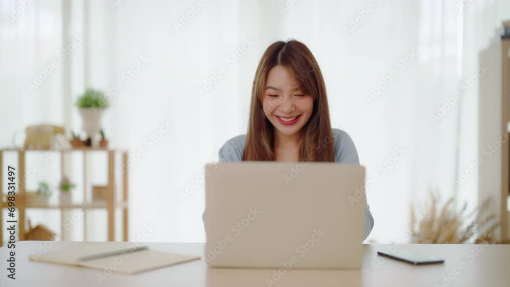 Funny euphoric young asian woman celebrating winning or getting ecommerce shopping offer on computer laptop. Excited happy girl winner looking at notebook celebrating success Funny euphoric young asian woman celebrating winning or getting ecommerce shopping offer on computer laptop. Excited happy girl winner looking at notebook celebrating success
