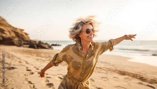 Fototapeta Naklejka Na Ścianę i Meble -  happy senior woman running on the beach