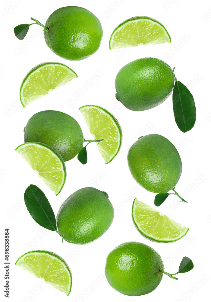 Fresh ripe limes and green leaves falling on white background