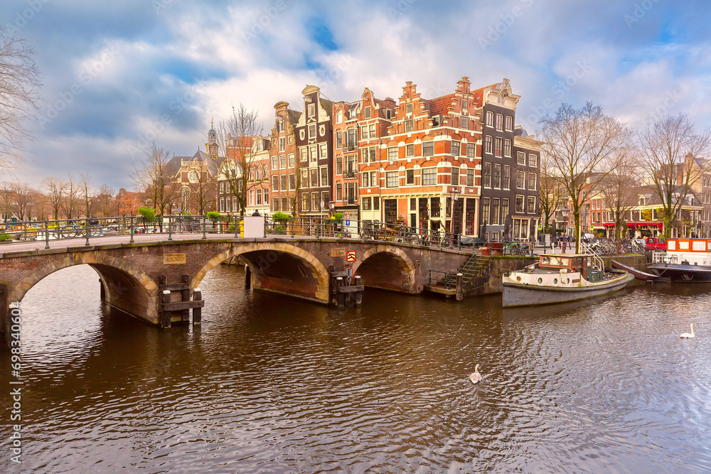 Amsterdam canal with bridge and typical houses, Holland, Netherlands.
