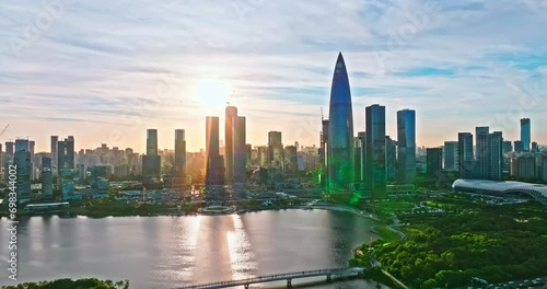 Aerial drone footage of Shenzhen skyline and modern building at sunset. Drone shooting backwards. photo