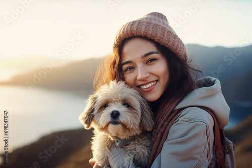 smiling woman hiking and traveling with backpack and dog, happy tourists on slope with epic view