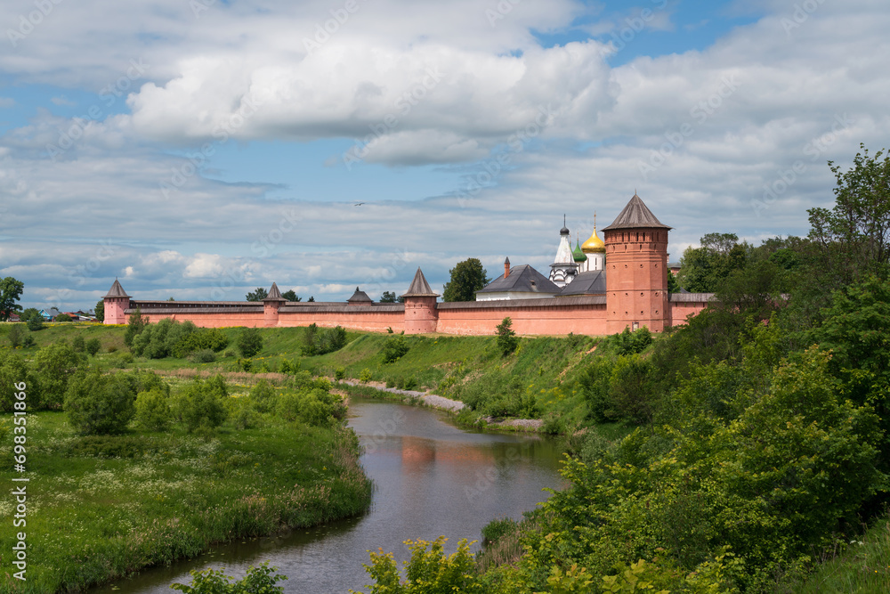 View of the Spaso-Evfimiev Monastery (a monastery of the Vladimir Diocese of the Russian Orthodox Church) on the bank of the Kamenka River on a sunny summer day, Suzdal, Vladimir region, Russia