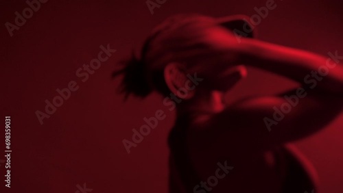 Studio shot of black woman dancing under neon lights	