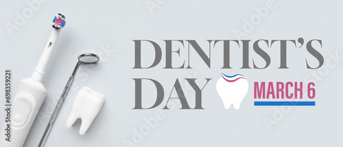 Banner for National Dentist's Day with dental mirror, electric toothbrush and model of tooth