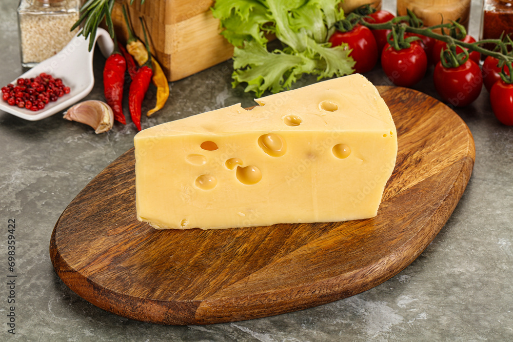 Swiss Maasdam cheese triangle over board Swiss Maasdam cheese triangle over board