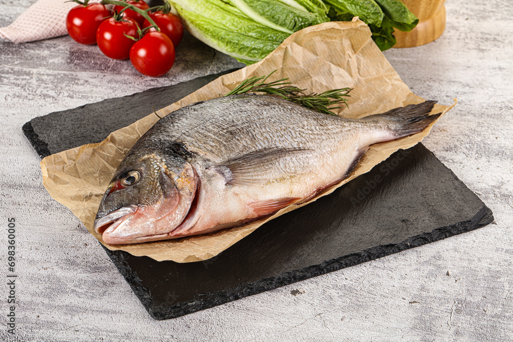 Raw dorada fish served rosemary