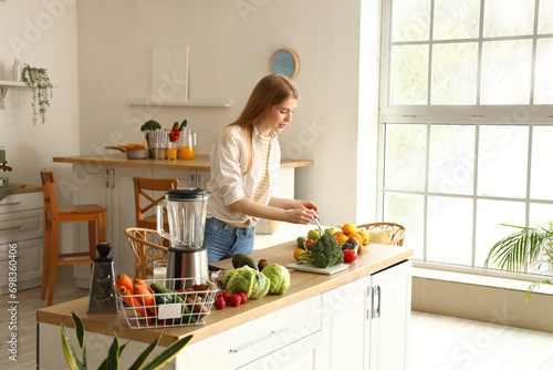 Young woman cooking healthy...