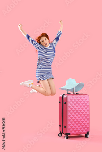 Jumping female tourist with...