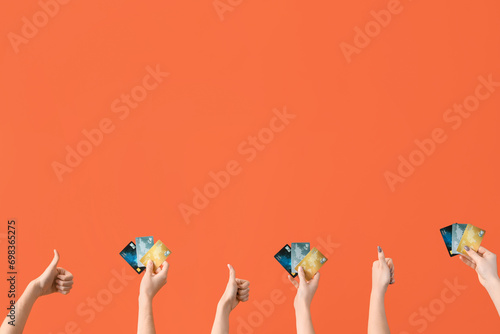 Multiple hands holding cred...