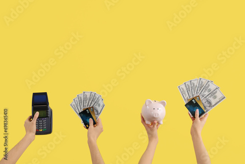 Women with credit cards, payment terminal, dollar banknotes and piggy bank on yellow background