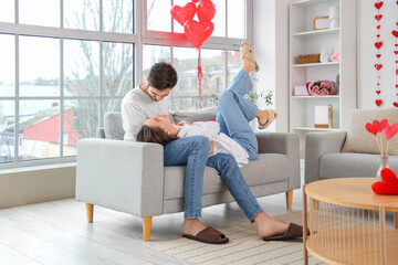 Happy young couple resting at home on Valentine's Day