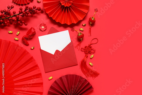Envelope with blank card  fortune cookies and Chinese symbols on red background. New Year celebration