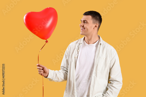 Smiling young man holding a...