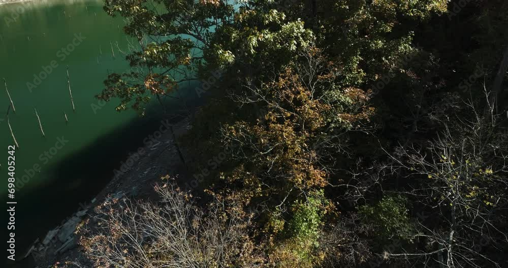 View From Above Of Autumn Trees And Lake Near Eagle Hollow In Arkansas, USA. aerial tilt-up reveal View From Above Of Autumn Trees And Lake Near Eagle Hollow In Arkansas, USA. aerial tilt-up reveal