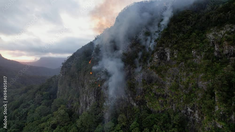 Smoke Rising From Wildfire Burning Part Of Currumbin Valley In Queensland, Australia. aerial pullback shot Smoke Rising From Wildfire Burning Part Of Currumbin Valley In Queensland, Australia. aerial pullback shot