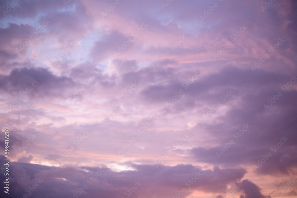 Beautiful lilac clouds and sun in the evening. Purple sunset in summer