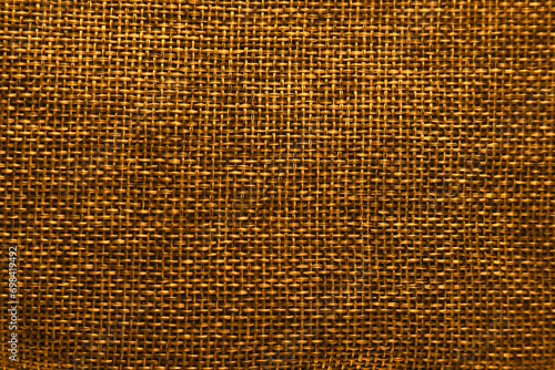 コーヒー豆など穀物類を入れるような荒い黄褐色の麻織り布地の平らな全面テクスチャー photo