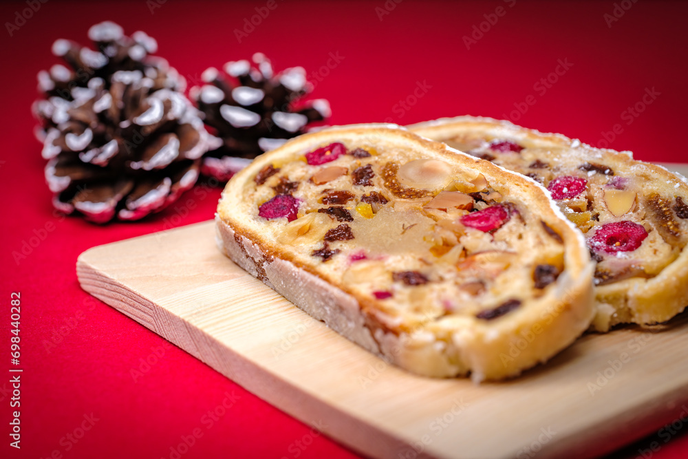 Cut open German Stollen cake, A fruit bread with nuts and dried fruits with powdered sugar traditionally served during Christmas time Cut open German Stollen cake, A fruit bread with nuts and dried fruits with powdered sugar traditionally served during Christmas time