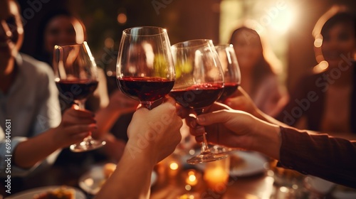 Closeup of group of people toasting with wine glasses at restaurant for dinner. AI generated image photo