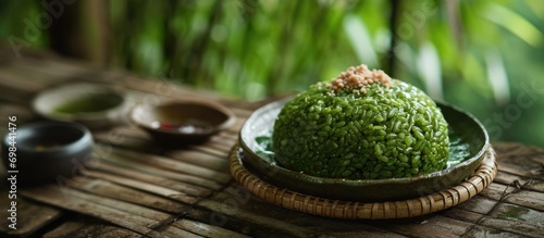 Com, a flattened and chewy green rice, is a Vietnamese cuisine dish tied to autumn. photo