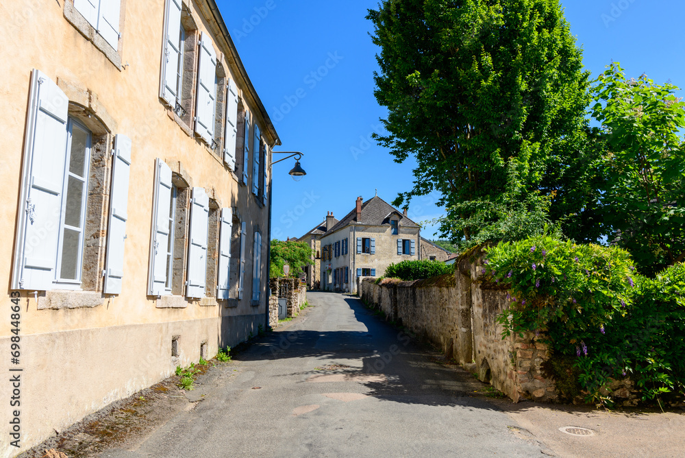 The ancient village in the green countryside in Europe, France, Burgundy, Nievre, Larochemillay, towards Chateau Chinon, in summer on a sunny day.