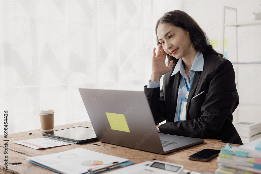 Tired Asian business woman Sleepy and bored from sitting at a desk for a long time and having office syndrome I feel a headache from looking at the screen for too long. Tired Asian business woman Sleepy and bored from sitting at a desk for a long time and having office syndrome I feel a headache from looking at the screen for too long.