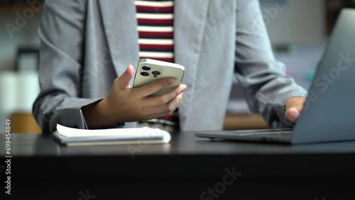 Female businessman working with smart phone and laptop and digital tablet computer.