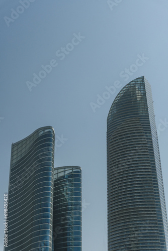 modern office buildings in abu dhabi skyline in summer heat clear sky