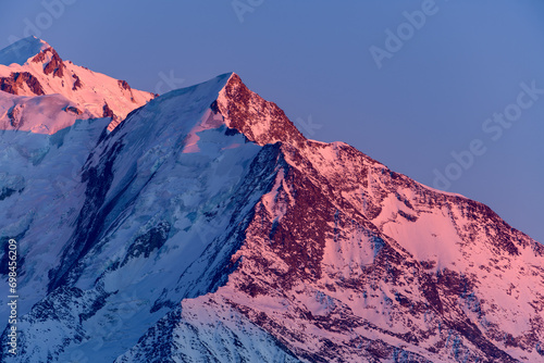 The pink colored Aiguille de Bionnassay in Europe, France, Rhone Alpes, Savoie, Alps, in winter on a sunny day.