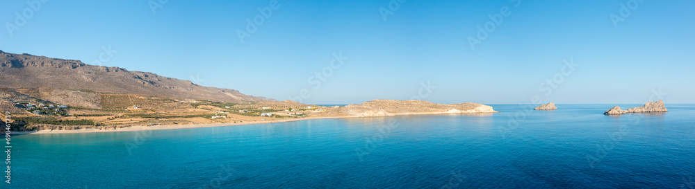 The sandy beach of Ambelou at the foot of the mountains , in Europe, Greece, Crete, towards Zakros, By the Mediterranean Sea, in summer, on a sunny day.