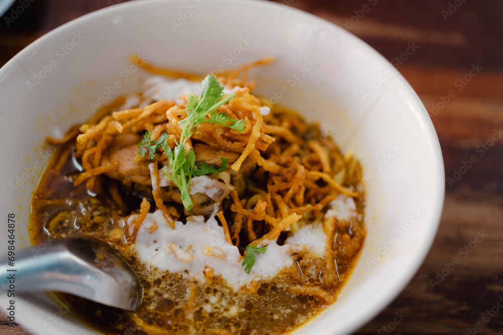 Khao Soi Recipe, Northern Style Curry Noodle Soup in a white bowl. Local Thai food Khao Soi Recipe, Northern Style Curry Noodle Soup in a white bowl. Local Thai food