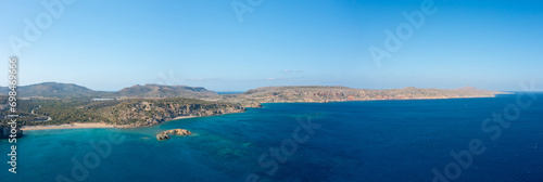 The panoramic view of the arid rocky coast and the sandy beach of Vai , Europe, Greece, Crete, towards Sitia, By the Mediterranean Sea, in summer, on a sunny day.