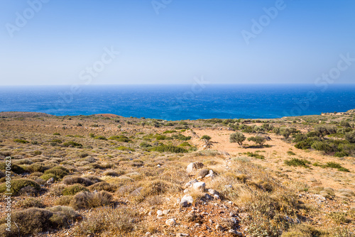 The arid rocky coast and its green countryside  in Europe  Greece  Crete  towards Matala  By the Mediterranean Sea  in summer  on a sunny day.