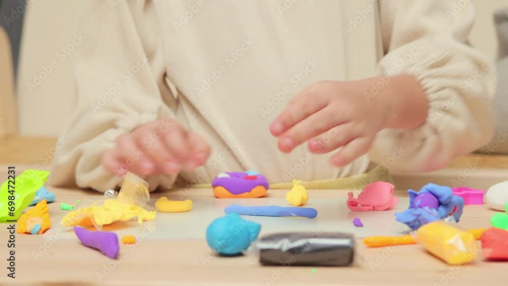 Kids engaged in sculpting. Early childhood creativity. Preschool crafting delight. Unrecognizable little girl playing with colorful pieces of plasticine Kids engaged in sculpting. Early childhood creativity. Preschool crafting delight. Unrecognizable little girl playing with colorful pieces of plasticine