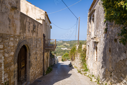 The alleys of the city center , in Europe, in Greece, in Crete, in Argiroupoli, towards Rethymno, in summer, on a sunny day. photo