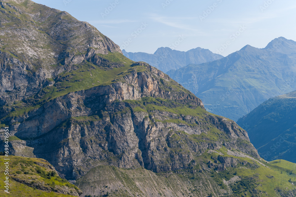 The Mountains around Gavarnie Gedre in the arid green countryside , Europe, France, Occitanie, Hautes-Pyrenees, in summer on a sunny day. The Mountains around Gavarnie Gedre in the arid green countryside , Europe, France, Occitanie, Hautes-Pyrenees, in summer on a sunny day.