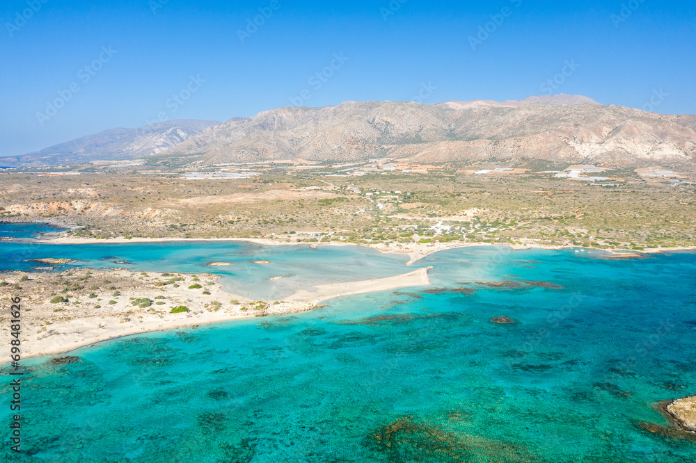 The sandy beach and its heavenly colored water, in Europe, Greece, Crete, Elafonisi, By the Mediterranean Sea, in summer, on a sunny day.