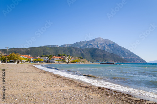 Fototapeta Naklejka Na Ścianę i Meble -  The beach on the rocky coast amid green countryside , Europe, Greece, Aetolia Acarnania, Kato Vasiliki towards Patras, by the Ionian Sea, in summer on a sunny day.
